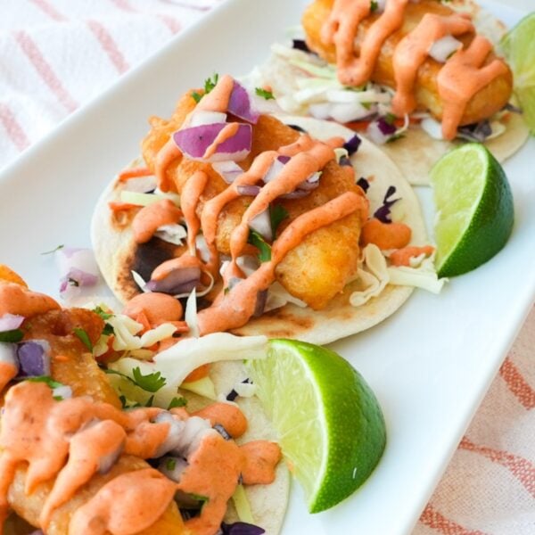 Baja fish tacos with crispy fried cod, shredded cabbage, diced red onion, cilantro, and chipotle mayo.