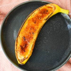 Banana creme brulee served inside banana peels with a caramelized sugar top.