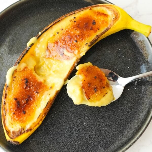 Banana creme brulee served inside banana peels with a caramelized sugar top.
