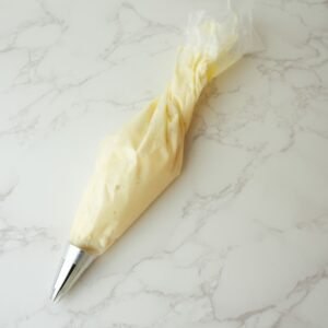 cheesecake filing in a piping bag