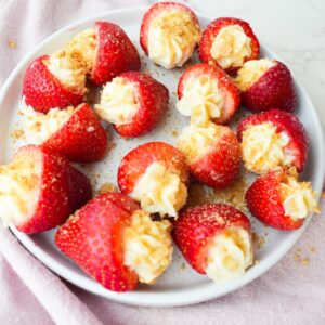 Fresh strawberries filled with cheesecake cream and topped with graham cracker crumbs.