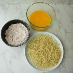 Panko bread crumbs, flour and eggs in separate bowls.