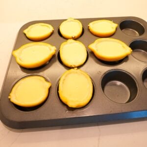 Lemon posset in lemon shells before setting in the fridge.