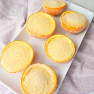 Frozen orange creamsicle cups served inside hollowed orange peels with a creamy orange filling.