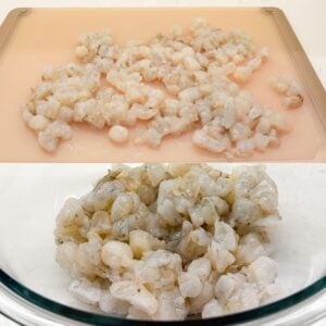 Shrimp chopped up on a cutting board and placed in a mixing bowl.