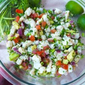Shrimp ceviche in a bowl with avocado, tomatoes, red onion, cilantro and jalapeño.