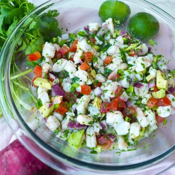 Shrimp ceviche in a bowl with avocado, tomatoes, red onion, cilantro and jalapeño.
