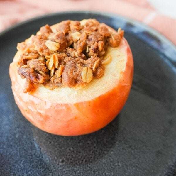 Stuffed baked apple on a plate.