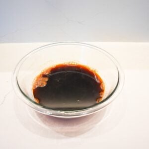 Thai tea strained into a glass bowl.