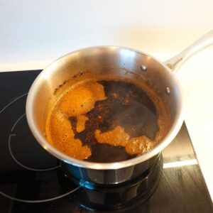 Thai tea brewing in a pot.