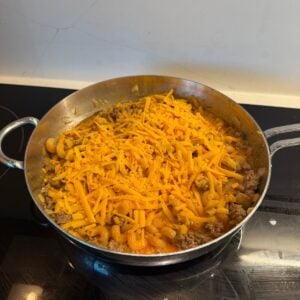 Shredded cheese over hamburger helper.