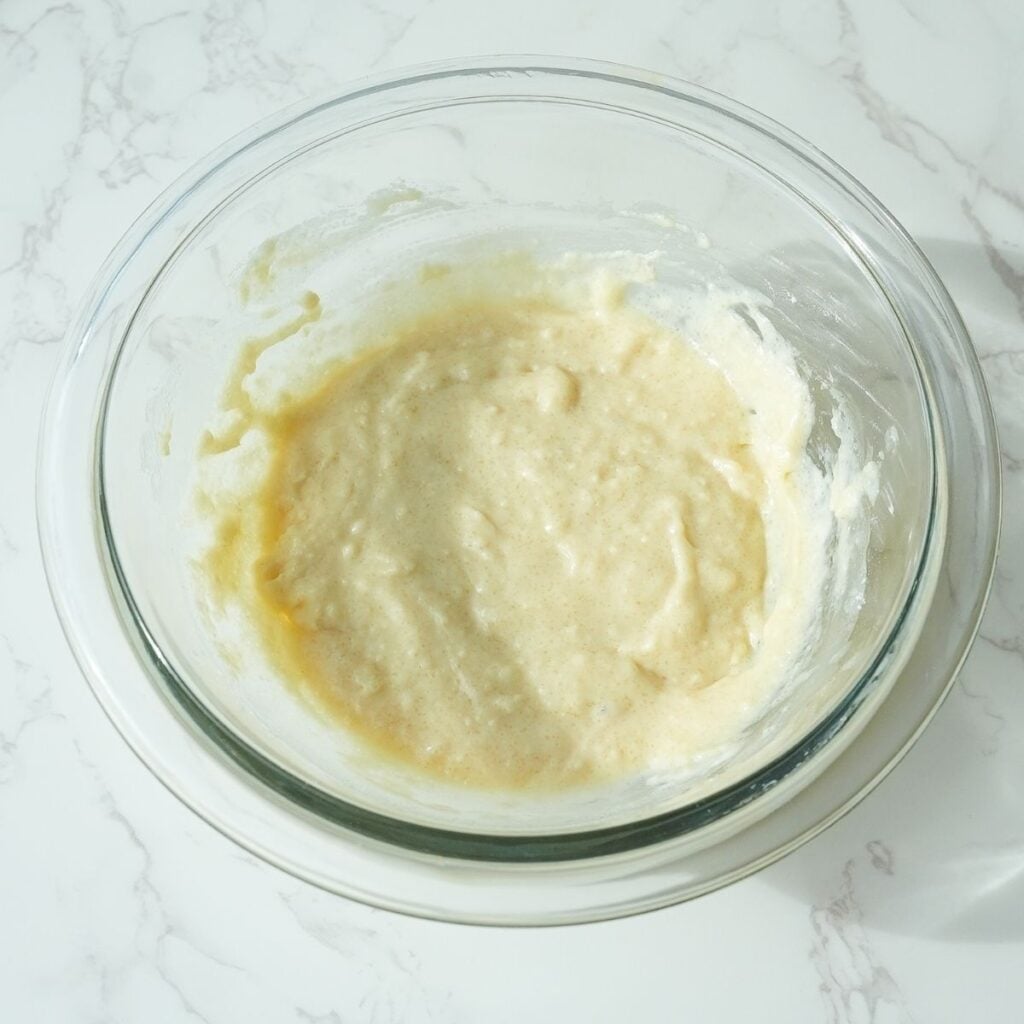 Batter for apple cobbler topping in a glass bowl.