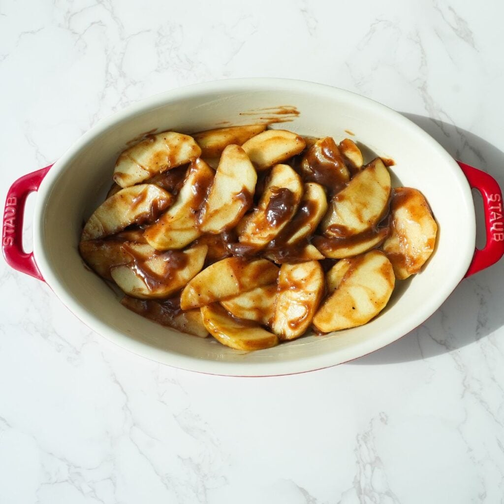 Apple cobbler filling in a baking dish.