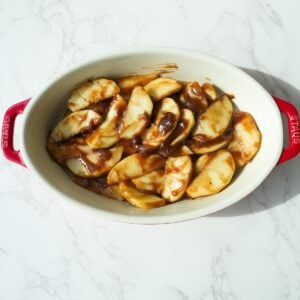 Apple cobbler filling in a baking dish.