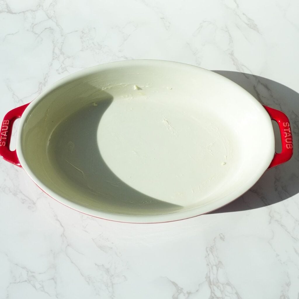 Oval baking dish greased with butter.