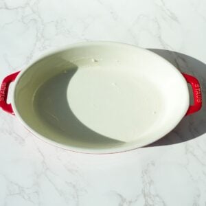Oval baking dish greased with butter.