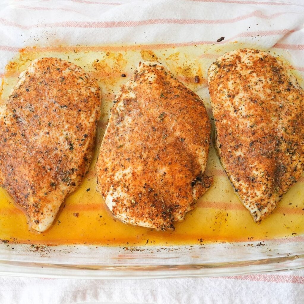 Baked chicken breast seasoned with paprika and herbs and topped with melted butter.
