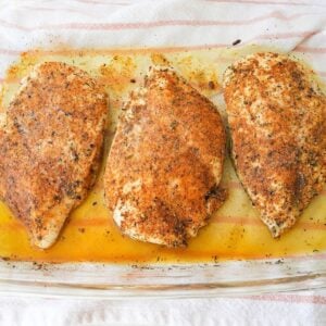 Baked chicken breast seasoned with paprika and herbs and topped with melted butter.