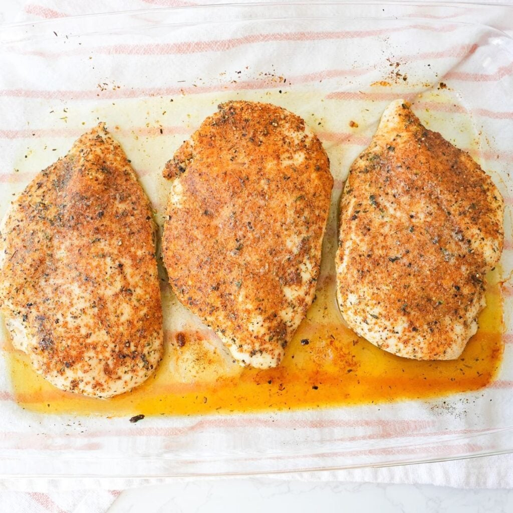 Baked chicken breast seasoned with paprika and herbs and topped with melted butter.