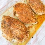 Baked chicken breast seasoned with paprika and herbs and topped with melted butter.