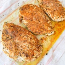 Baked chicken breast seasoned with paprika and herbs and topped with melted butter.