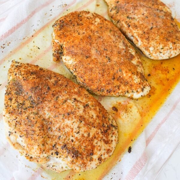 Baked chicken breast seasoned with paprika and herbs and topped with melted butter.