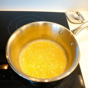 Garlic and butter cooking in a saucepan.