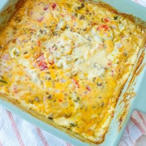 Baked Rotel dip with seasoned ground beef, melted cheese, tomatoes and onions, jalapeños.