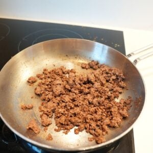 Ground beef cooking in a pan.