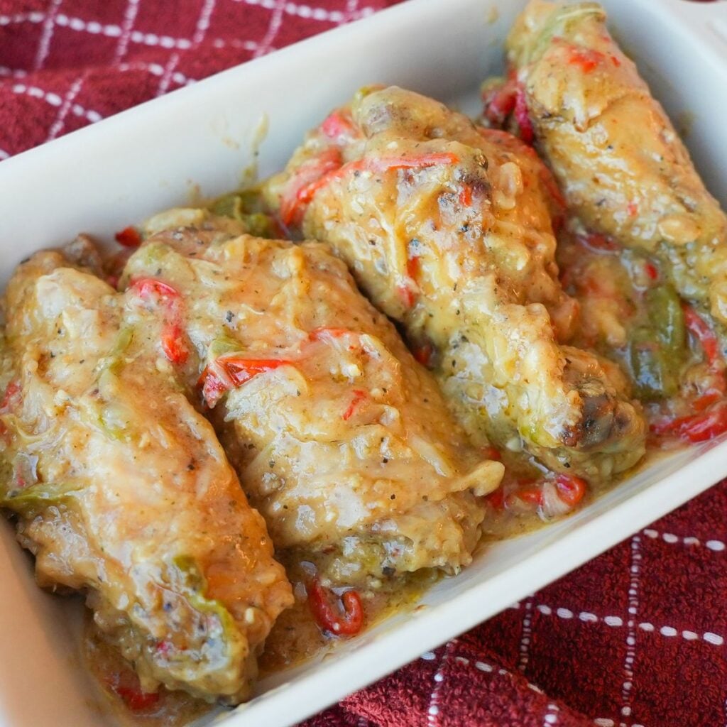 Smothered turkey wings covered in homemade gravy with sliced onions and peppers.
